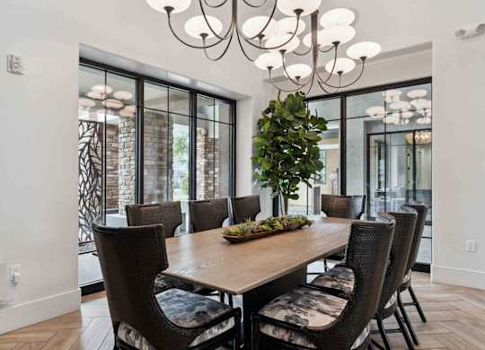 A dining room with a wooden table and chairs.