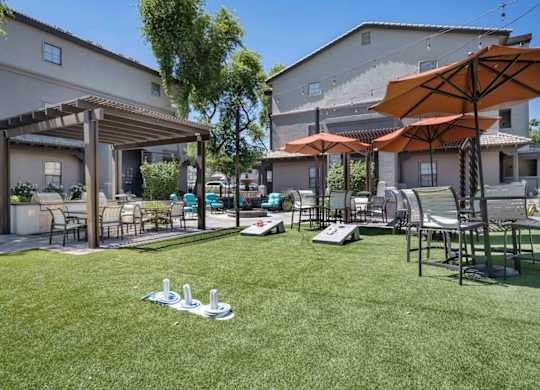 A sunny day at a residential area with a lawn and a patio.