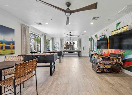 A room with a pool table and a bar area.