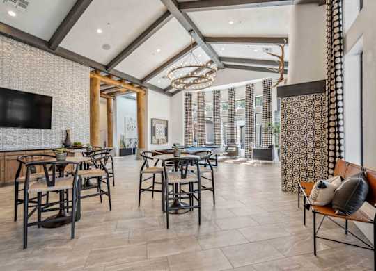 A modern dining room with a large table and chairs.