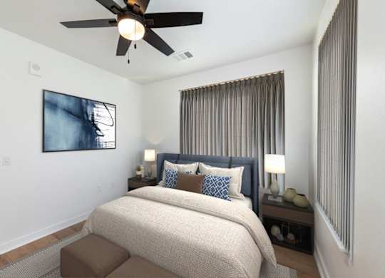 A bedroom with a bed, a ceiling fan, and a painting on the wall.