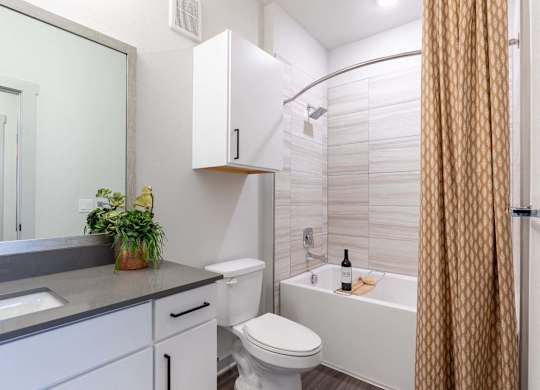 A bathroom with a white toilet, sink, and bathtub.