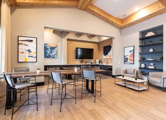 A modern living room with a wooden floor and a large dining table.