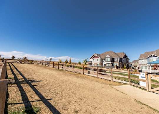 A row of houses with a fence in front of them.