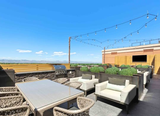 an outdoor patio with chairs and a table with a view of a field