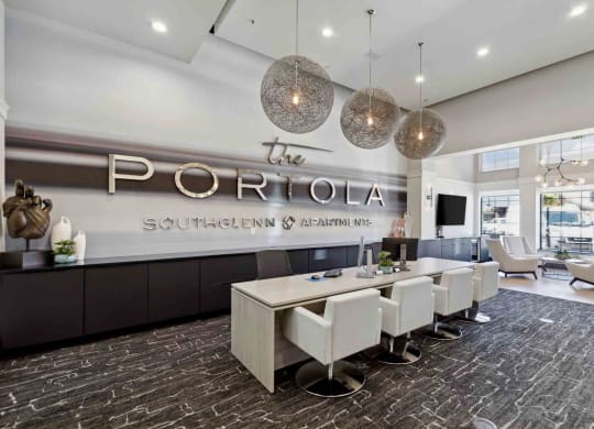 a room with a long table and chairs in front of a sign that says the portola