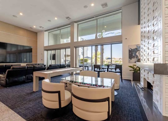 a game room with a foosball table and chairs