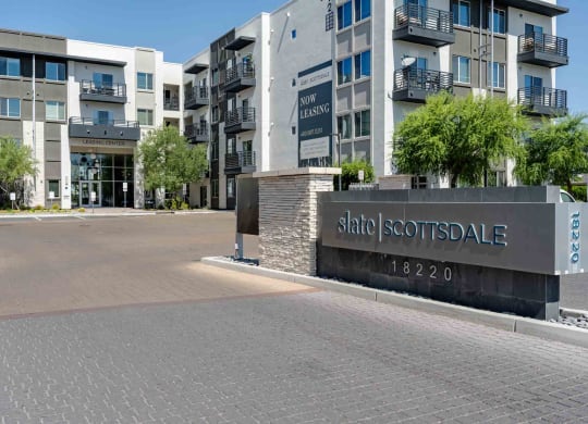 a view of the main entrance to slate scottsdale apartments in the background