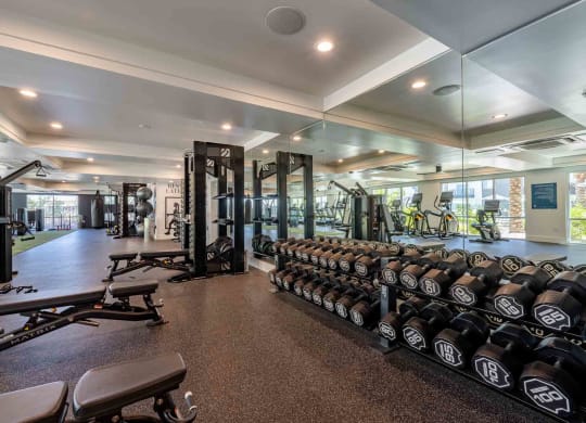 a spacious fitness center with weights and other exercise equipment