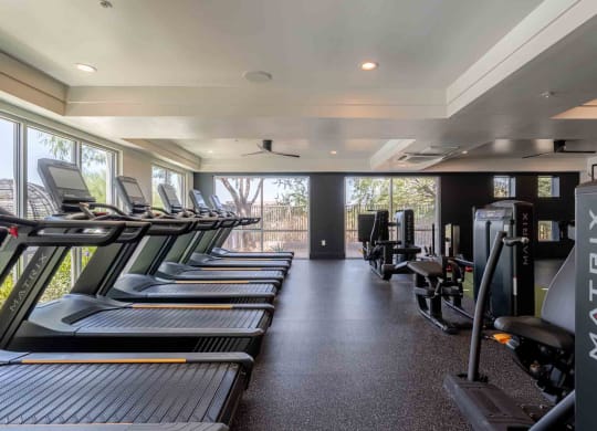 a row of treadmills and exercise machines in a fitness room at slate scottsdale