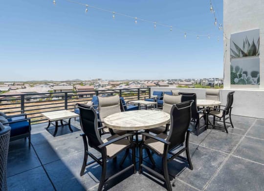 tables and chairs on a rooftop patio with a view of scottsdale arizona
