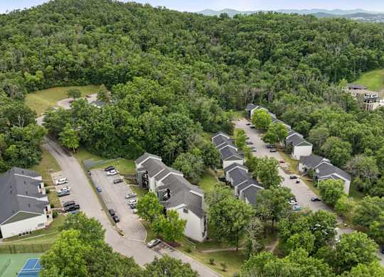A bird's eye view of a residential area with houses and cars.