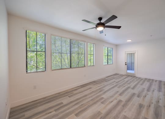 a bedroom with hardwood floors and a ceiling fan