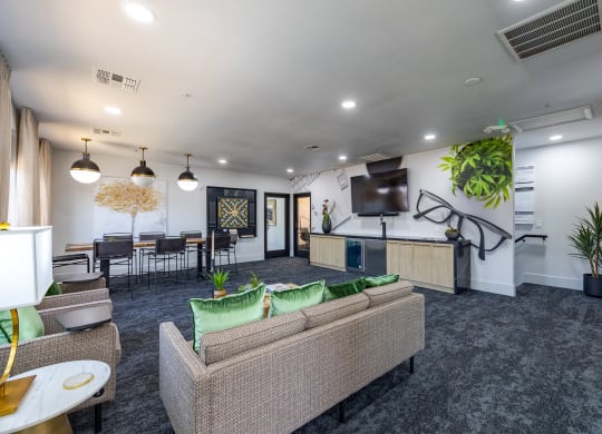 an open concept living room with a kitchen and dining area