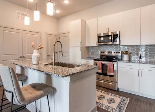 A kitchen with a bar area and a refrigerator.