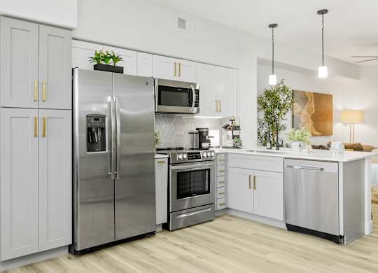 a kitchen with stainless steel appliances and white cabinets