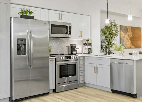 a kitchen with stainless steel appliances and white cabinets