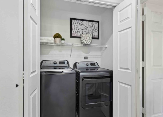 a small laundry room with a washer and dryer