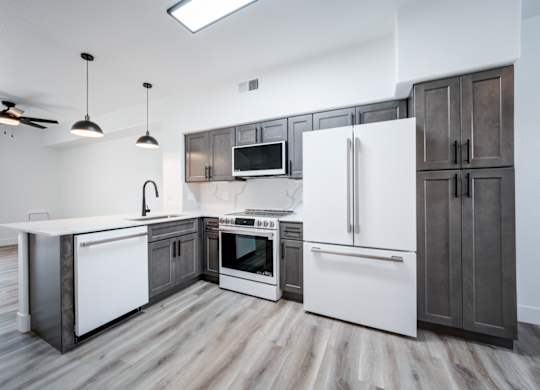 a kitchen with white appliances and wooden cabinets