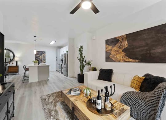 a living room with a white couch and a wooden coffee table on top of a furry rug