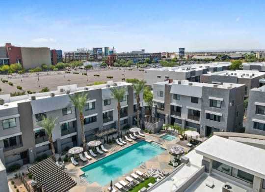 an aerial view of an apartment complex with a swimming pool