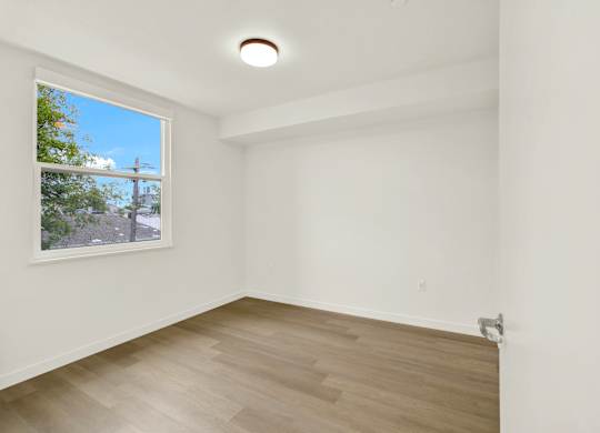 A room with a window and a wooden floor at 26FIFTY Apartments, Berkeley 94704