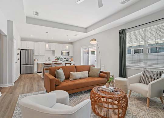 A modern living room with a kitchen in the background. at Zora University, Charlotte, 28213