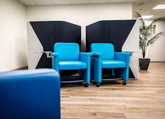 a row of blue chairs in an office