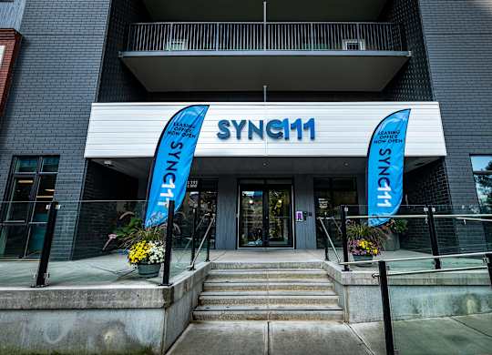 a building with two blue banners in front of it
