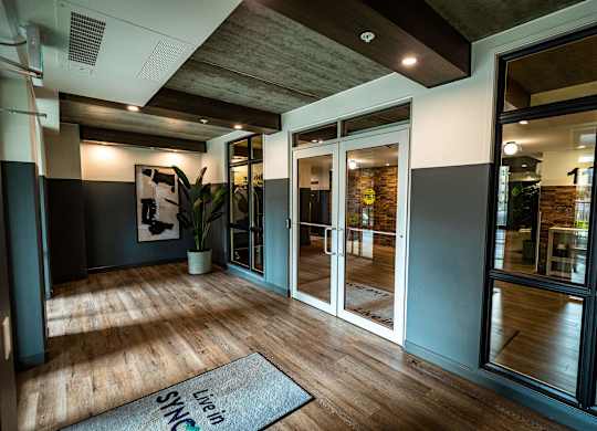 a living room with glass doors and a rug