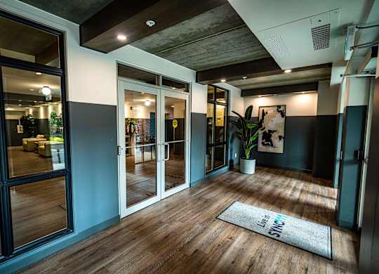 a living room with glass doors and a rug