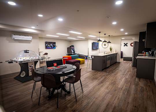 a game room with a table and chairs and a jukebox