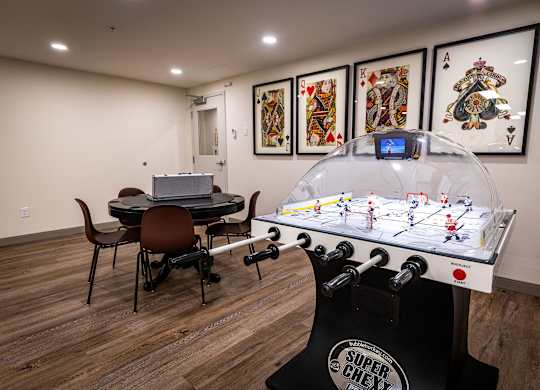 a game room with a foosball table and a ping pong table