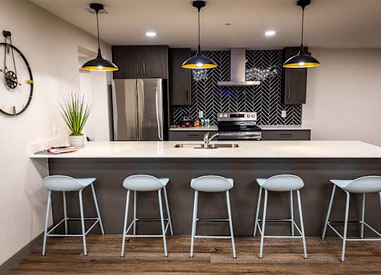 a kitchen with a counter top and bar stools