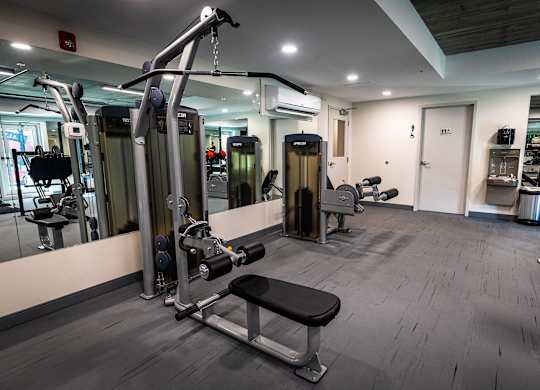 a gym with weights and other equipment in a building