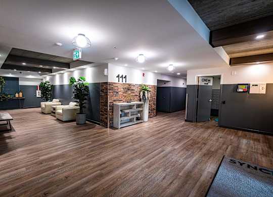 a large room with a wood floor and a lobby