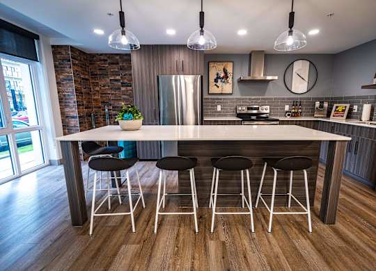 a kitchen with a large island and bar stools