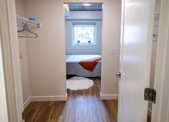 a bedroom with a bed and a window in a small room