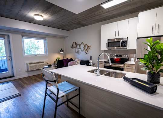 a kitchen with a white counter top and a sink