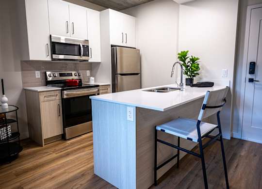 a kitchen with a white counter top and a sink