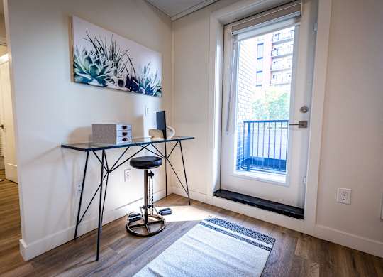 a living room with a glass table and a window
