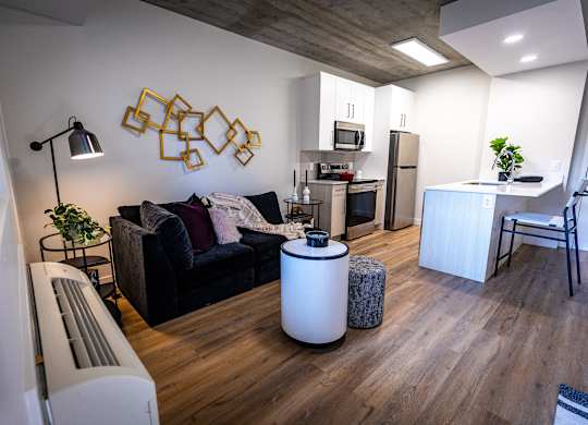 a living room with a couch and a kitchen