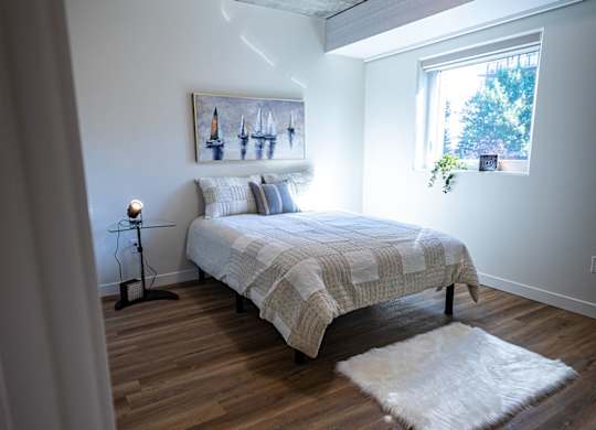 a bedroom with a bed and a window