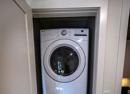 a washing machine and dryer in a small closet