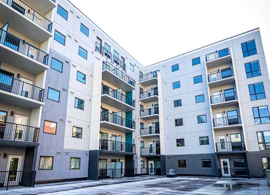 an empty street in front of an apartment building
