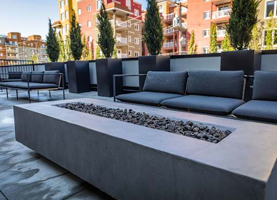 a seating area with couches and a fire pit