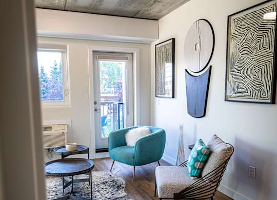 a living room with a couch and a chair and a table