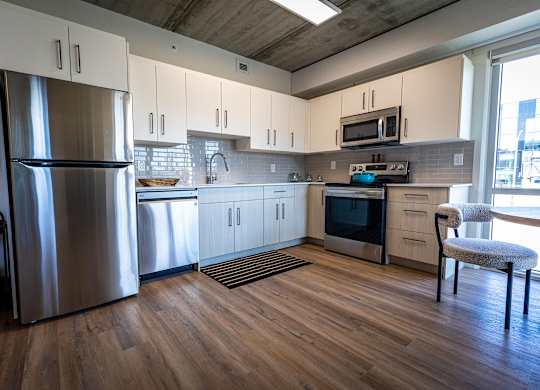 a kitchen with stainless steel appliances and white cabinets