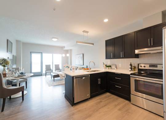A modern kitchen with a dining table and chairs.