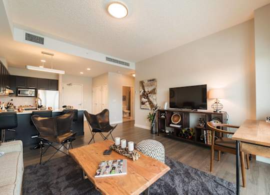 A living room with a wooden coffee table and a television.